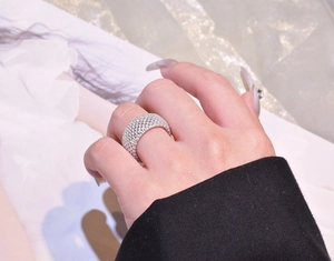 Close-up of a wide 925 silver ring featuring full pavé-set sparkling crystals