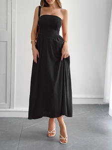 Close-up of the elegant black strapless A-line maxi dress with textured fabric detail