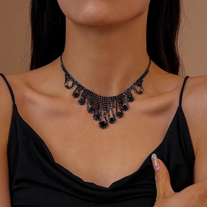 Detail of vintage luxury layered fringe necklace with black rhinestones on neck