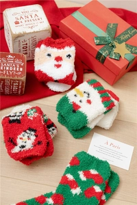 Detail of soft coral fleece Christmas socks featuring festive Santa and snowman patterns