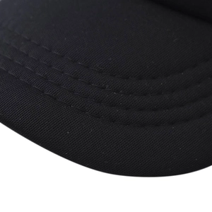 Macro detail of high-quality triple stitching on a black baseball cap curved brim
