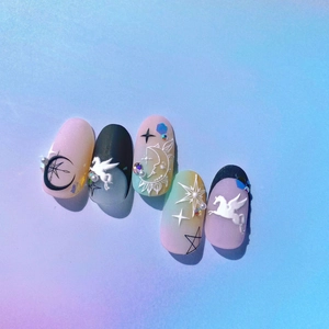 Detail of 5D embossed nail stickers featuring white Pegasus, moon and star designs