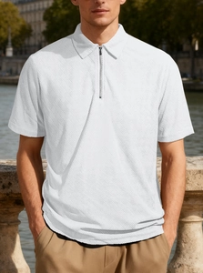 Close-up of men's white half-zip polo shirt featuring unique diamond weave texture fabric