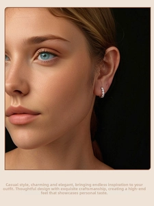 Detail of luxury S925 sterling silver hoop earrings with shimmering moissanite on ear