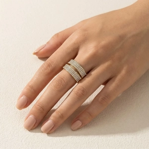 Detail of wide double-layer gold titanium ring featuring sparkling pave cubic zirconia stones