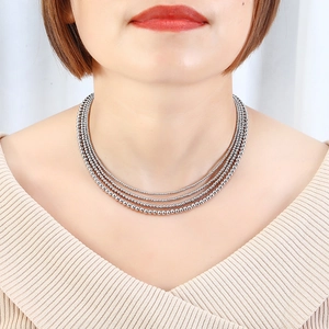 Close-up of multi-layer stainless steel beaded necklace with polished silver beads