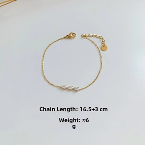 Detailed view of golden stainless steel bracelet with three teardrop cubic zirconia stones
