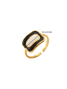Detail shot of golden flower ring with black and white enamel and 15mm size indicator
