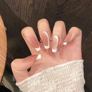 Detail of pink cat-eye press-on nails with white French tips and long ballerina shape