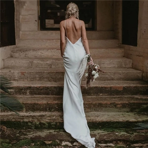 Elegant white satin dress featuring a deep V-back design and thin spaghetti straps