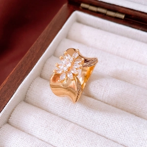 Macro shot of 18K gold plated floral ring with white zircons in a velvet gift box