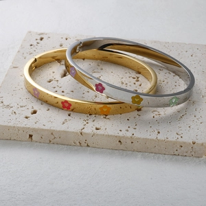 Polished stainless steel flower bracelets in gold and silver with colorful enamel floral patterns