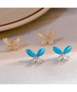 Macro detail of elegant butterfly stud earrings with cat-eye stone and crystal inlay