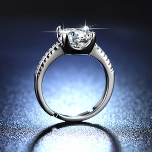 Detailed close-up of a 1 carat round moissanite ring with four-prong silver setting