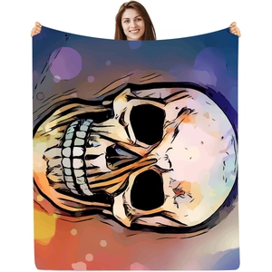 Vibrant skull print flannel blanket with colorful artistic design held by a model
