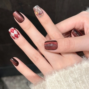 Cat eye cherry red press-on nails with hand-painted plaid and glitter accents