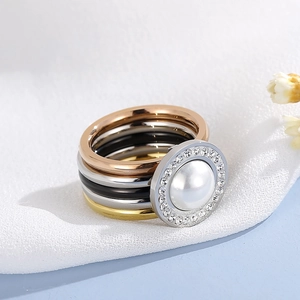 Macro shot of multi-color stacked rings set with pearl and crystals in high detail