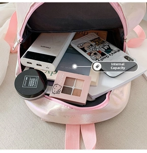 Spacious interior of pink holographic mermaid backpack showing storage for daily essentials