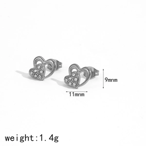 Macro view of double heart stud earrings with silver plating and rhinestone details