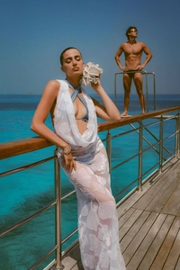 Detail of white mesh beach cover-up with seashell crochet pattern on a yacht