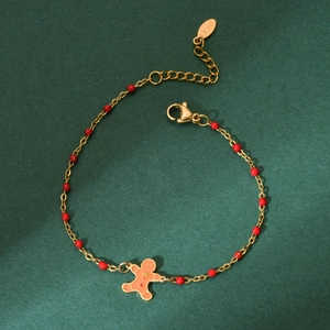 Detail of Christmas gingerbread man charm bracelet with red beads on stainless steel chain