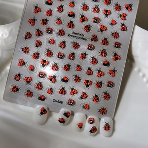 5D embossed ladybug nail art stickers with red and black insect designs on white nails