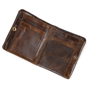 Macro shot of the premium leather wallet interior with card slots and a brass snap button