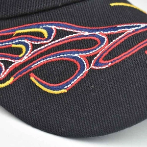 Close-up of 3D flame embroidery detail on a premium black cotton baseball cap