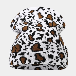 Detail showing cow print pattern texture on a thick knit beanie for winter season