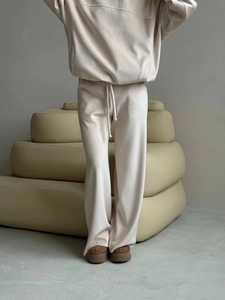 Minimalist beige lounge set with long-sleeve hoodie and wide-leg pants on model