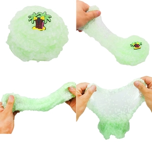 Detailed view of green translucent slime with bubbles and coconut tree accessory being stretched