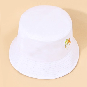 Close-up detail of cartoon frog and mushroom embroidery on the white cotton bucket hat