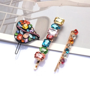 Set of three colorful rhinestone hair clips with heart and bar shapes on gold metal base