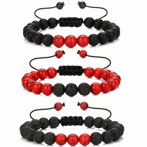 Close-up of lava stone beaded bracelets with adjustable hand-woven cords in red and black
