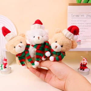 Detailed view of three mini Christmas plush bears with red hats and striped scarves