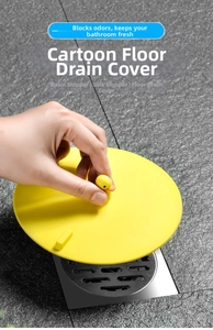 Lifting the yellow duck silicone drain cover on a bathroom floor tile for odor blocking
