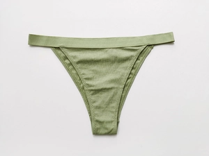 Detail of grass green ribbed cotton panties with seamless stitching and soft texture