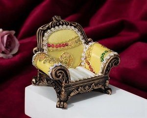 Detail view of vintage sofa jewelry box with yellow silk and velvet ring slots