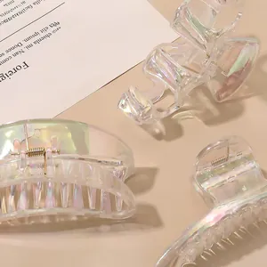 Detailed view of iridescent acrylic hair claws with elegant metallic spring finish