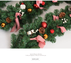 Close-up of 2.7m Christmas garland with pine cones, red ornaments and checkered bows