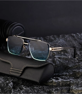 Detail of luxury square frame sunglasses with golden double bridge and leather case