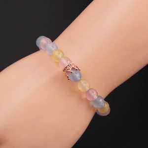 Detail of 8mm faceted multi-color beads bracelet with rose gold crown charm on model