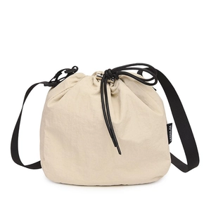 Off-white drawstring bucket bag with black adjustable wide strap for daily casual wear