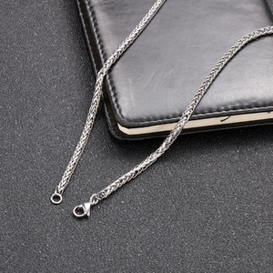 Detailed view of silver wheat chain necklace in stainless steel with lobster clasp