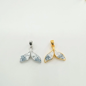 18K gold and silver fishtail pendants with zircon stones on a white background