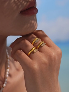 Close-up of three 18k gold plated stainless steel rings set with pavé cubic zirconia