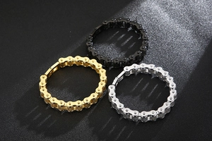 Three retro stainless steel bike chain bracelets in gold, silver, and black colors