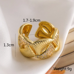 Close-up of 18K gold-plated scalloped ring with zircons on elegant silk background