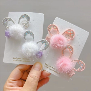 Detail of plush rabbit ear hair clips with sparkling rhinestones on handmade display card