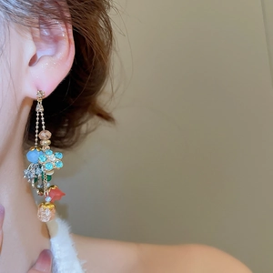 Detail of crystal flower drop earrings with colorful bead tassels and silver needle studs